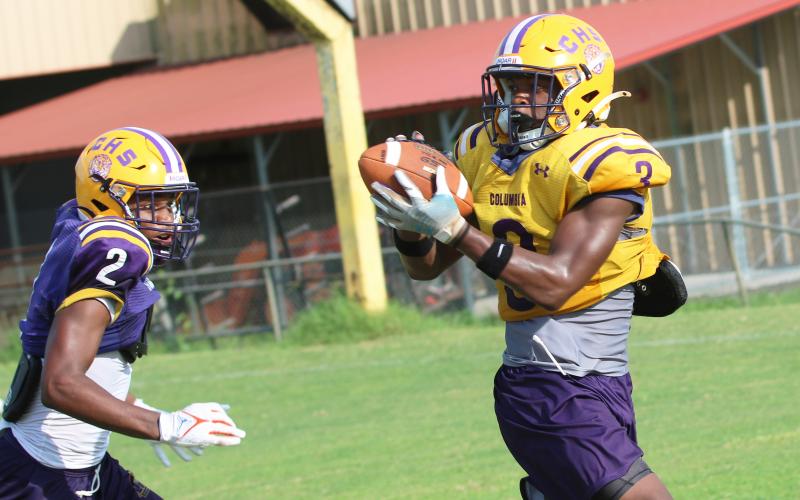 Columbia receiver Zamarion Jones (3) catches a pass ahead of defensive back Vondarius Lane (2) during Wednesday’s practice. (JORDAN KROEGER/Lake City Reporter)