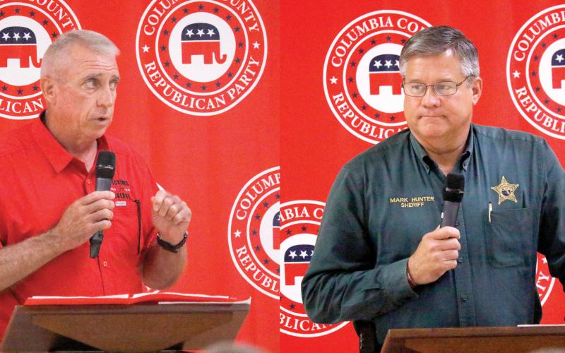 Wallace Kitchings (left) and Mark Hunter, candidates for Columbia County sheriff, speak to voters on Thursday at the Columbia County Republican Party's political rally at the Florida Gateway Fairgrounds. (Photos by JAMIE WACHTER/Lake City Reporter)