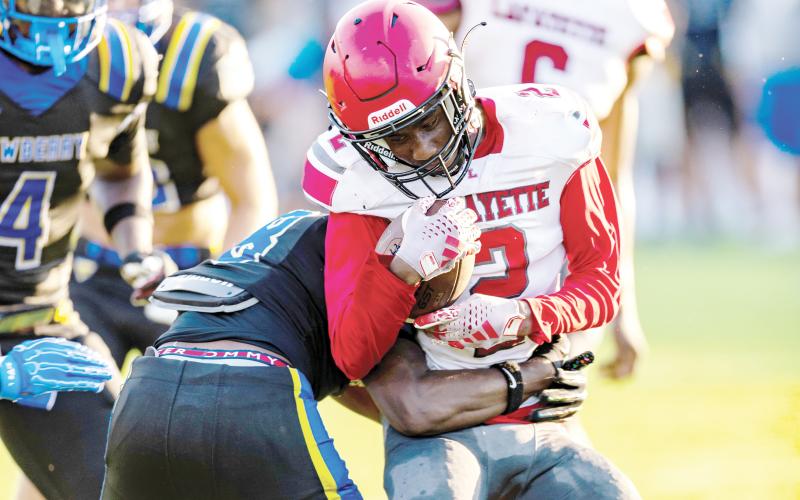 Lafayette receiver Jordan Murphy takes a hit from a Newberry defender after a catch in their Preseason Classic on Aug. 15. (JACK HOWDESHELL/Lake City Reporter)