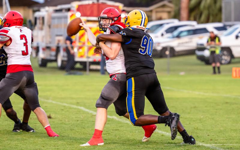 Lafayette quarterback Tucker Higginbotham is sacked by Newberry defensive lineman Dyllan Strappy during Thursday's Preseason Classic. (JACK HOWDESHELL/Special to the Reporter)