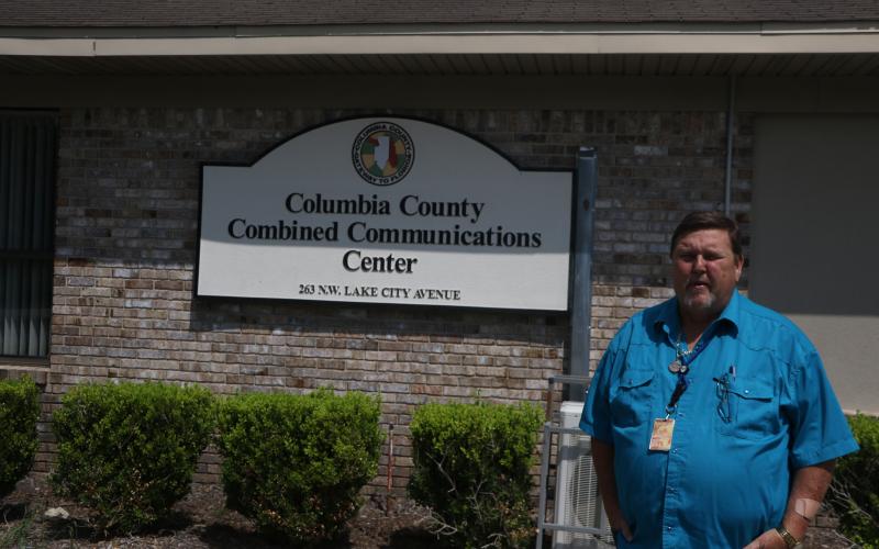 Tom Brazil, Columbia County’s 911 director, stands outside the Combined Communications Center on Tuesday. The county and City of Lake City consolidated their emergency dispatch last week. There have been no major issues so far, Brazil said. (MORGAN MCMULLEN/Lake City Reporter)
