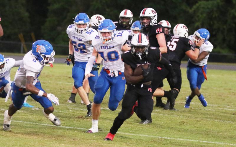 Fort White running back Keimarion Neal races up the field against Taylor County last Friday. (MORGAN MCMULLEN/Lake City Reporter)
