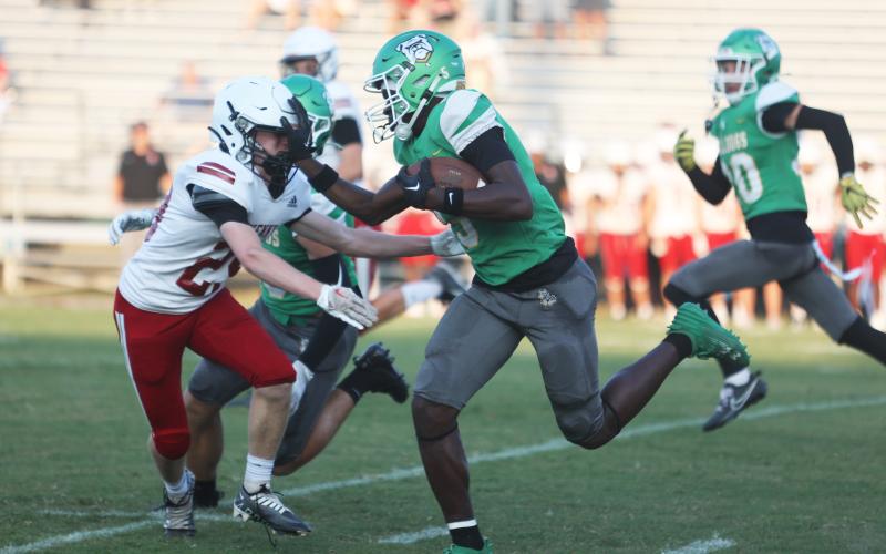 Suwannee receiver MJ Rossin stiff arms Bishop Kenny’s Brady Wagner as he returns the opening kickoff for a touchdown during Friday’s Preseason Classic. (PAUL BUCHANAN/Special to the Reporter)