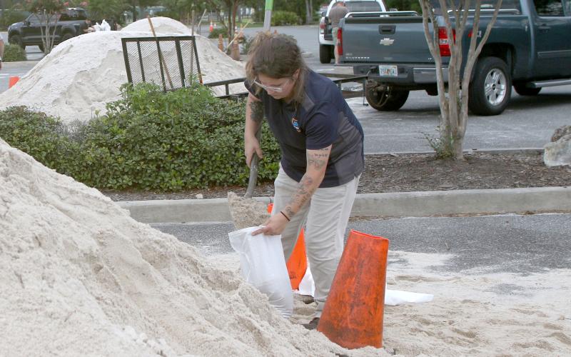 Amber Clark fills up a sandbag at Southside Sports Complex as she prepares for Tropical Storm Debby. (TONY BRITT/Lake City Reporter).