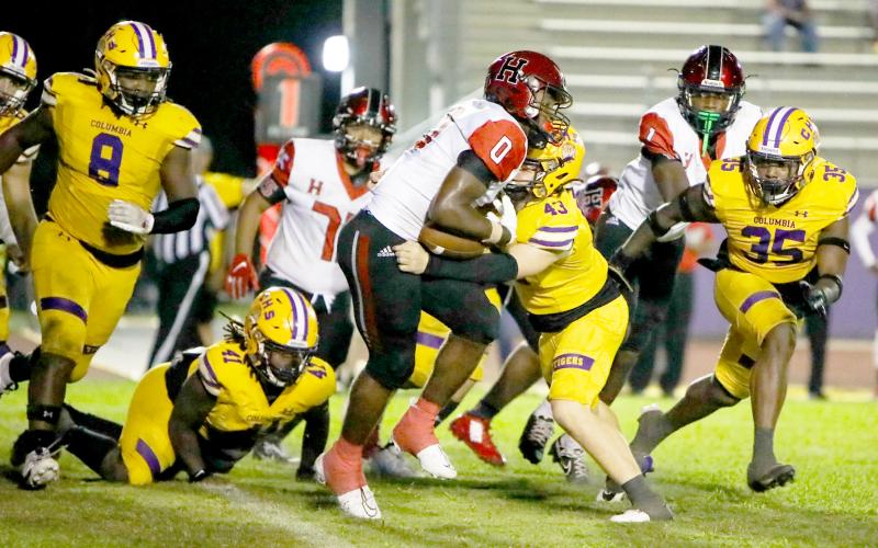 Columbia linebacker Bryson Grinstead wraps up Hillsborough running back Tariq Johnson last Friday night. (BRENT KUYKENDALL/Lake City Reporter)