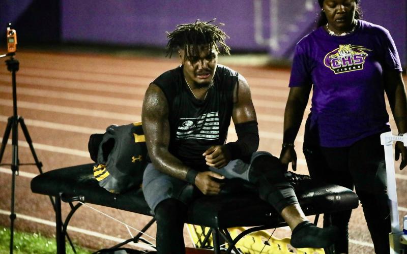 Columbia linebacker Chris Jordan sits on the trainer's table after suffering a high-ankle sprain during Friday's game against Madison County. (BRENT KUYKENDALL/Lake City Reporter)