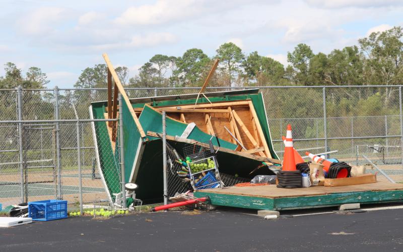 A shed holding supplies for the Suwannee High tennis program was demolished by Hurricane Helene, leaving equipment on the ground next to the tennis courts at the school. (LILLY WACHTER/Lake City Reporter)