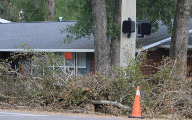 Storm debris is piled up alongside SW McFarlane Avenue in Lake City on Monday afternoon. Cleanup crews will now begin the process of picking up the debris alongside streets and roadways in both the City of Lake City and Columbia County. (JACK WACHTER/Lake City Reporter)