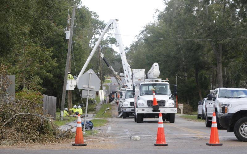Contractors helping Florida Power &amp; Light work on restoring power to residences along SW Grandview Street in Lake City on Monday afternoon. Electric companies all said Monday that they expect 95% power restoration in the county in the next couple of days. (JACK WACHTER/Lake City Reporter)