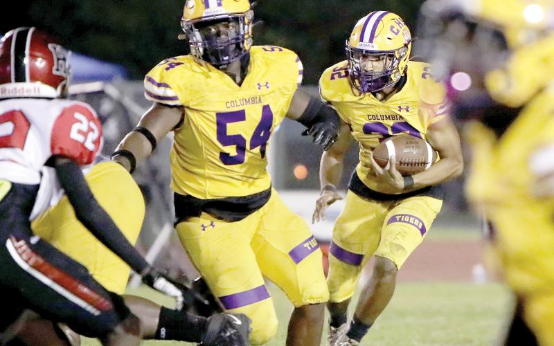 Columbia running back TC Smith follows a block from Issac Kimble against Hillsborough on Friday night. (BRENT KUYKENDALL/Lake City Reporter)