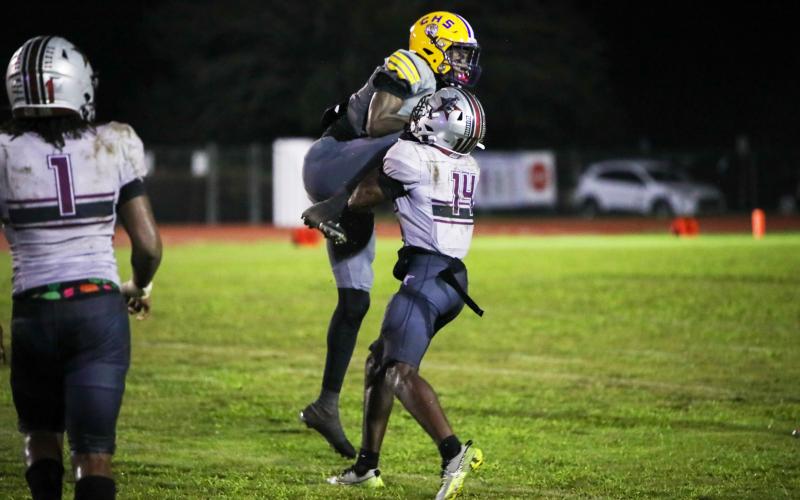 Columbia receiver Kyren Caldwell gets wrapped up by Madison County defensive back Sean Williams following a catch on Friday. (BRENT KUYKENDALL/Lake City Reporter)