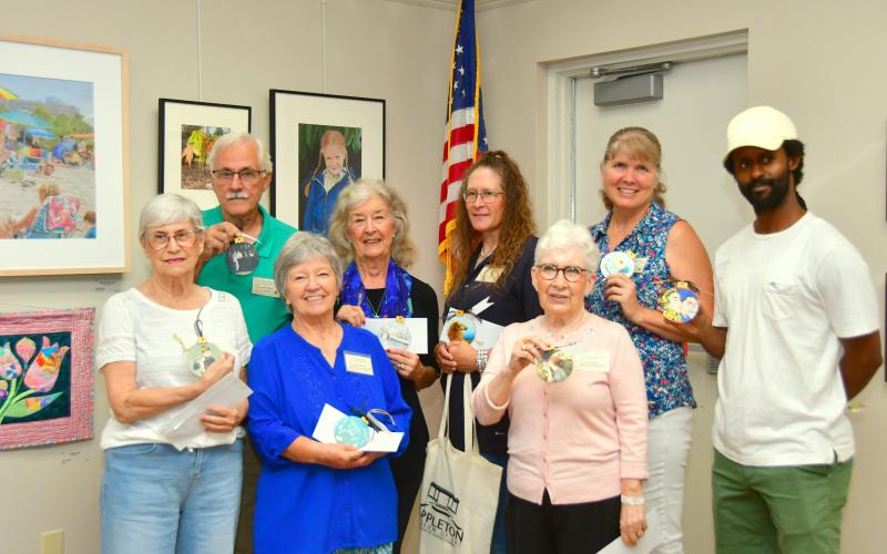 The Live Oak Artists Guild honored the winners in the 26th annual Autumn Artfest during a reception Sept. 7 at the Suwannee River Regional Library branch in Live Oak. The winners in the fine arts exhibition included, front row, Judith Adams (front row, from left), Glinda Pennock, Anda Chance; back row, Rob Wolfe, Christie Stanton, Renee Shiska and Sharon Hester. Jason Holland (back row, right) was the subject of Connor Billups’ honorable mention drawing. (ROB WOLFE/Special to the Reporter)