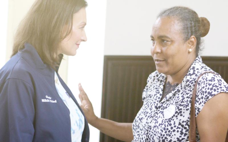 Nikki Fried, the Florida Democratic Party chair, talks with Nice Wells, of Gainesville, after a rally for the Kamala Harris presidential campaign at the Columbia County Woman’s Club on Sunday. (TONY BRITT/Lake City Reporter)
