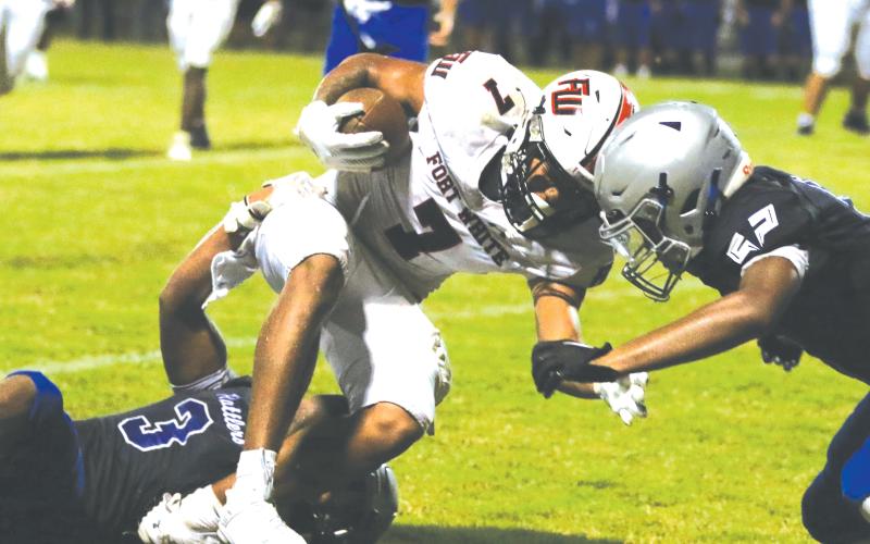 Fort White receiver Tafari Moe gets gang tackled after a catch Friday against Belleview. (MORGAN MCMULLEN/Lake City Reporter)