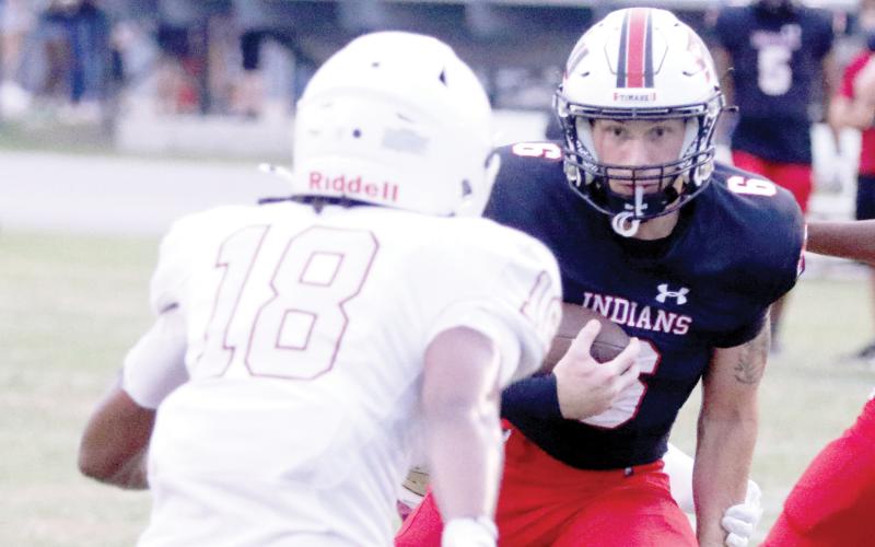Fort White running back Hayden McCrory eyes a North Marion defender on a run Friday night. (MORGAN MCMULLEN/Lake City Reporter)