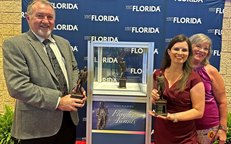 Suwannee County Tourist Development Council Director Jimmy Norris and Marketing Coordinator Charissa Setzer hold the Flagler Awards that the county received for their tourism marketing campaign, ‘Soul of Suwannee.’ Pictured with Norris and Setzer is Danah Heye with Madden Media, an advertising agency that works with Suwannee TDC. (COURTESY)