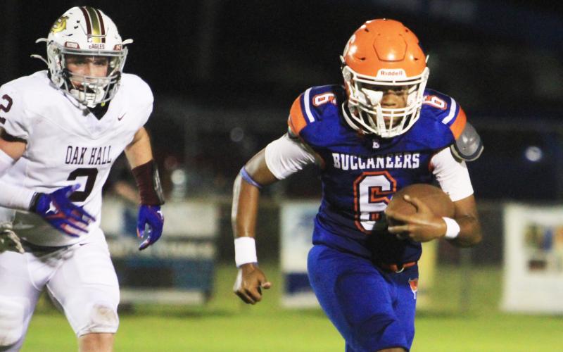 Branford quarterback Damian Herrera scrambles up the field against Oak Hall on Aug. 23. (PAUL BUCHANAN/Lake City Reporter)