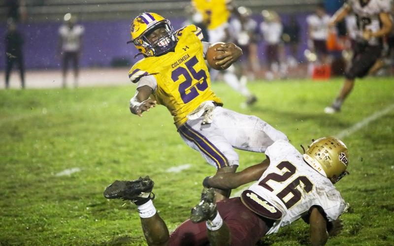 Columbia running back Jerome Horne is tackled St. Augustine defensive back Marquell Elmore on Wednesday night. (BRENT KUYKENDALL/Lake City Reporter)