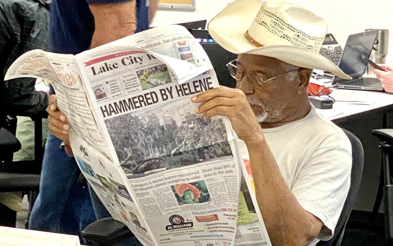 Columbia County Commission Chairman Ron Williams reads the weekend edition of Lake City Reporter Saturday before the start of the county’s daily emergency operations briefing. County and emergency officials meet daily inside the secure bunker. (TODD WILSON/Lake City Reporter)