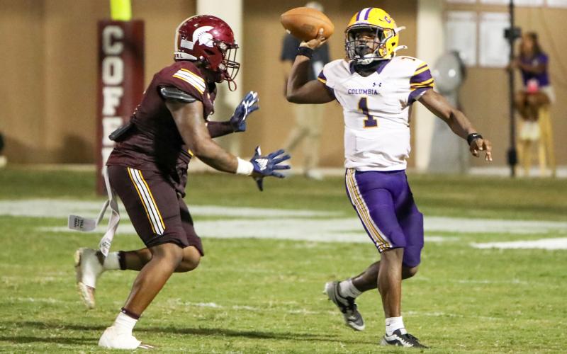 Columbia quarterback Zamarion Jones throws a pass under pressure during last Friday’s game against Coffee. (BRENT KUYKENDALL/Lake City Reporter)
