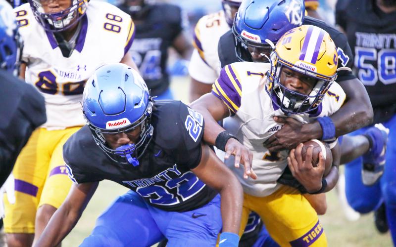 Columbia quarterback Zamarion Jones is tackled by Trinity Christian defensive back Kaleel Vereen on Friday. (BRENT KUYKENDALL/Lake City Reporter)