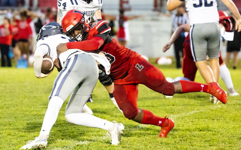 Lafayette’s Zamarion Hawkins wraps up a Brookwood runner last Friday night. (JACK HOWDESHELL/Lake City Reporter)