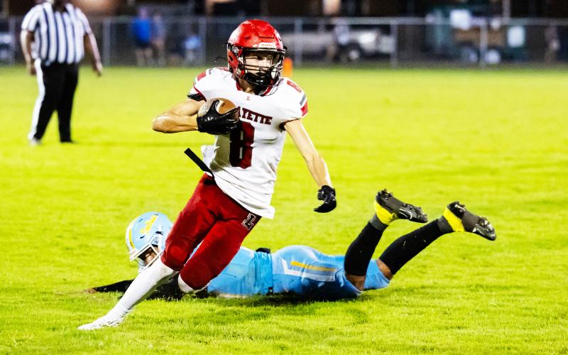 Lafayette receiver Parker Hill evades a Chiefland defender during last Friday’s game. (JACK HOWDESHELL/Lake City Reporter)