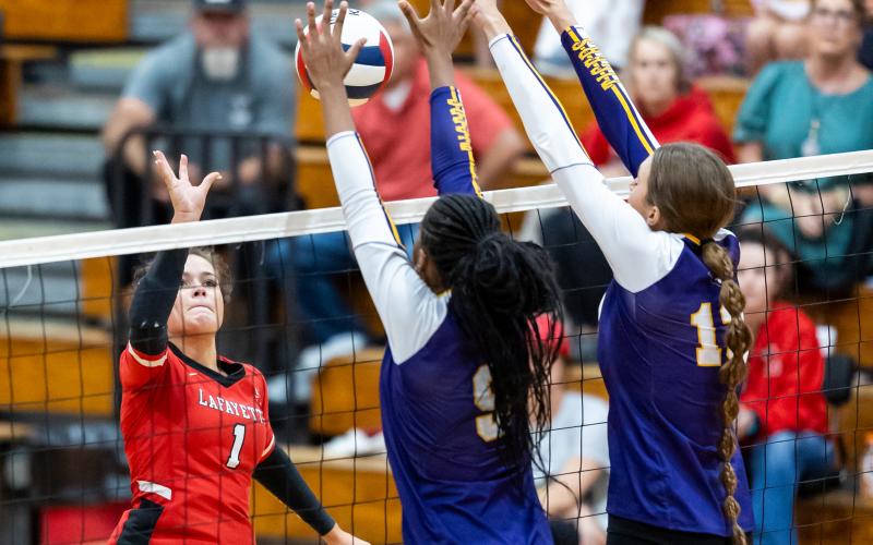 Lafayette hitter Brooke Lamb sends a shot over the net against Columbia on Tuesday. (JACK HOWDESHELL/Lake City Reporter)