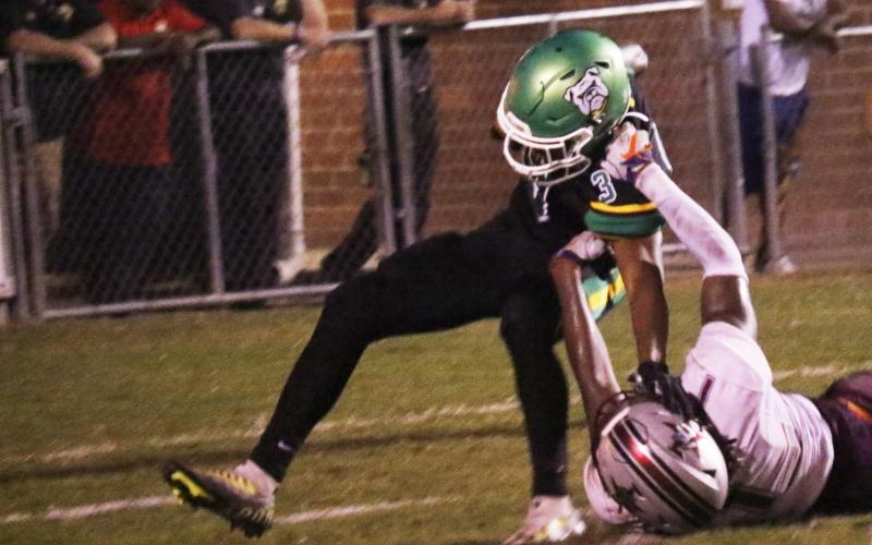 Suwannee running back Lou Jack Smith is tackled for a loss by Madison County’s Kemari Scurry on Friday. (JAMIE WACHTER/Lake City Reporter)