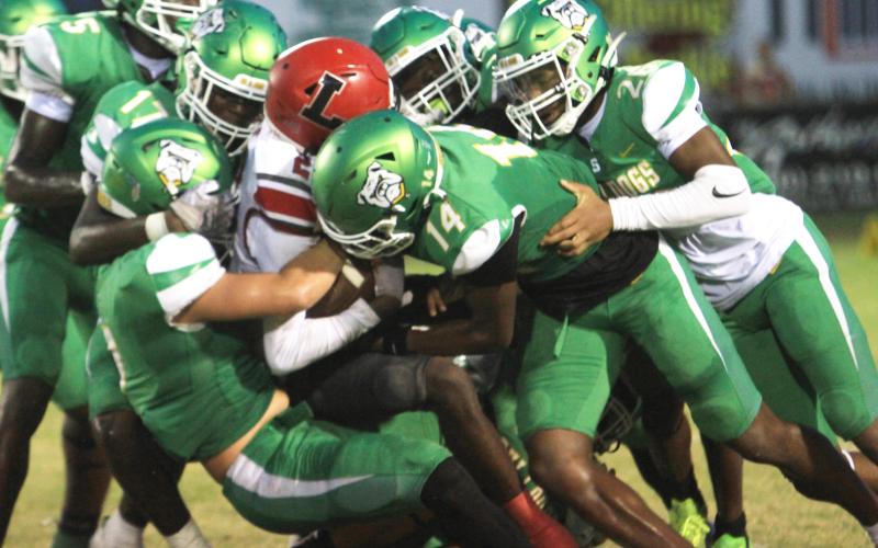 Suwannee’s defense swarms to tackle Lafayette receiver Jordan Murphy last Friday. (PAUL BUCHANAN/Lake City Reporter)