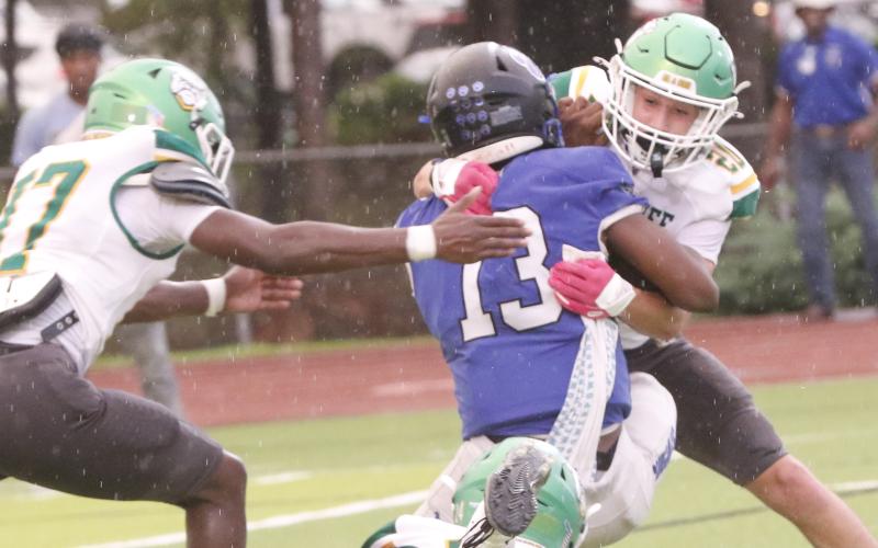 Suwannee safety Kamden Lang tackles Godby quarterback Lazarus Chambers last Friday. (JAMIE WACHTER/Lake City Reporter)