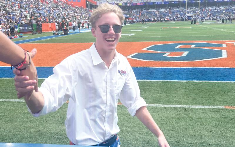 Florida Mic Man Drew Hingson, 19, of Lake City, greets Gator fans in the student section at The Swamp on Saturday. Hingson, was selected for the Mic Man job 10 days before the home opener and joined the Florida Cheer Squad after an open tryout on campus. He is a sophomore at UF. (COURTESY)