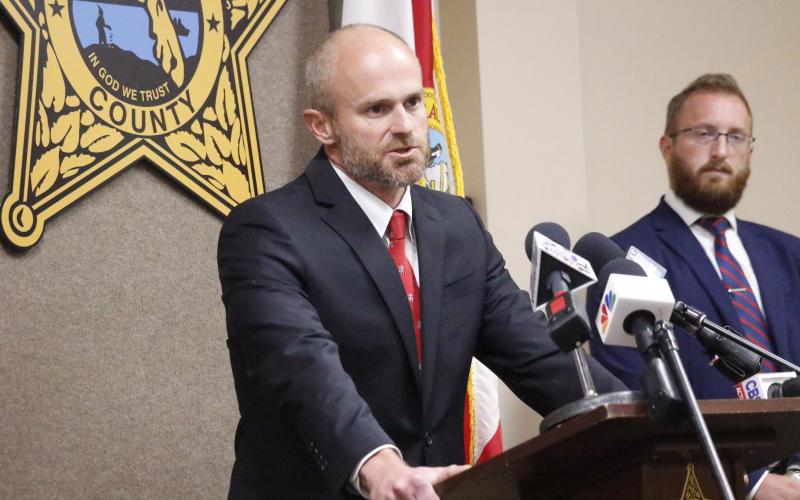 John Durrett, state attorney for the Third Judicial Circuit, said Wednesday that social media threats are not a joke, warning anyone that makes a threat will face consequences for their actions. Assistant State Attorney Chase Larsen looks on. (JAMIE WACHTER/Lake City Reporter)