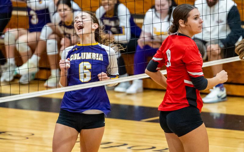 Columbia hitter Sinei Wood (6) celebrates a point while Lafayette middle blocker Sophia Kendrick (9) looks on during Tuesday’s match. (JACK HOWDESHELL/Lake City Reporter)