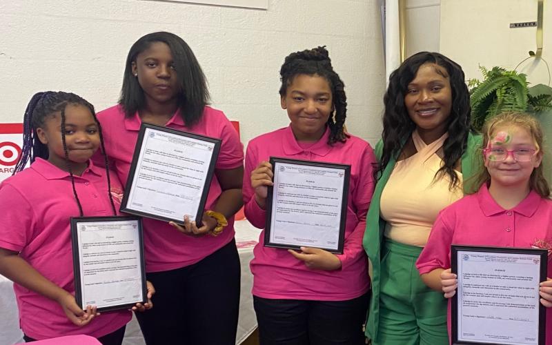 Young Women of Excellence members Lanashia Peterson (from left), Janaisha Peterson, Graciela Gerard, Mrs. Thayla Mullins (Assistant Principal, Lake City Middle School), and Bonnie McKerley pose for a photograph following a recent event. (COURTESY)