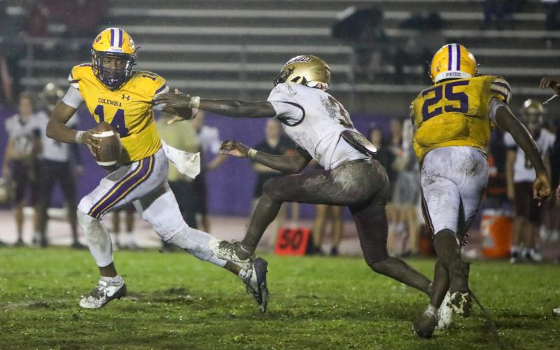 Columbia quarterback Xavier Collins runs away from pressure applied by St. Augustine defensive back Braylon James on Sept. 25. (BRENT KUYKLENDALL/Lake City Reporter)