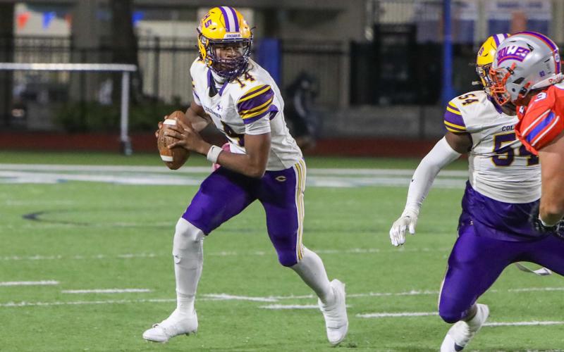Columbia quarterback Xavier Collins rolls out to pass against Bolles last Friday. (BRENT KUYKENDALL/Lake City Reporter)