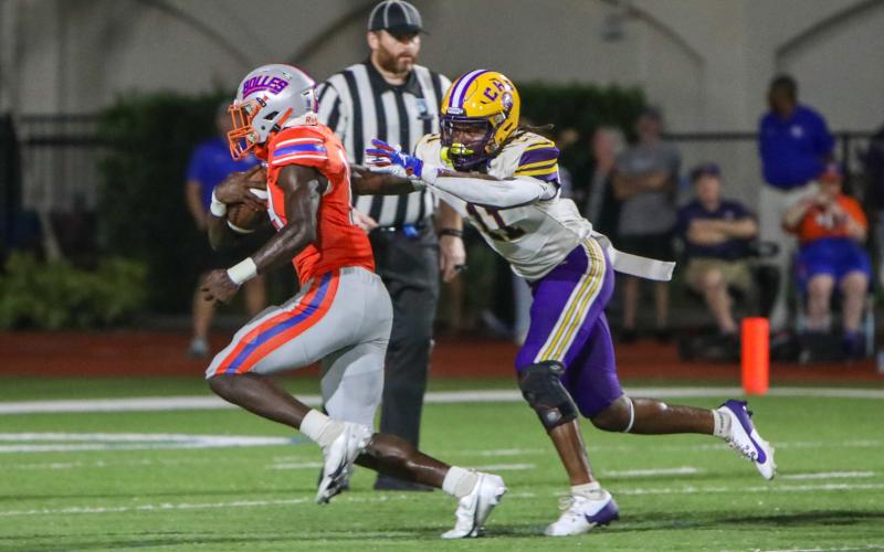 Columbia safety Da’jon Brown tries to wrap up Bolles running back Tyrone Neal on Friday night. (BRENT KUYKENDALL/Lake City Reporter)