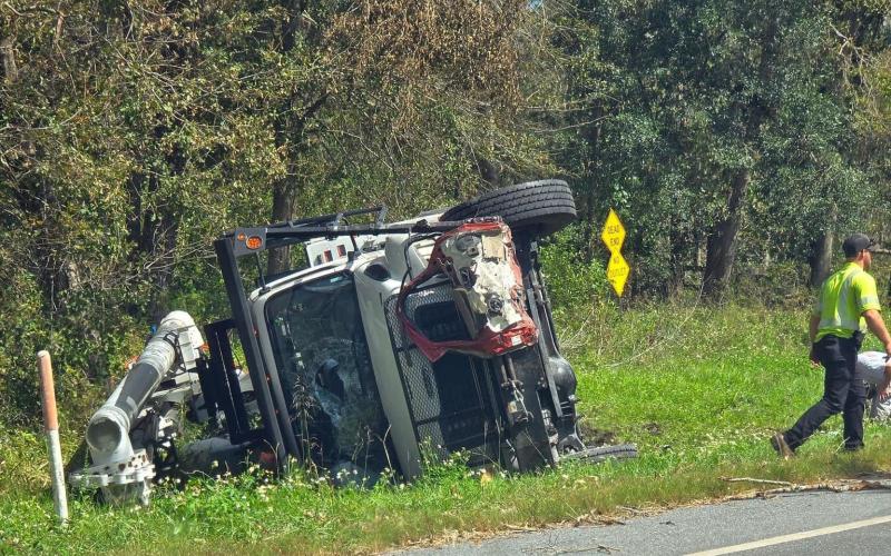 Three linemen from North Carolina were injured when their bucket truck overturned as part of a four-vehicle crash northwest of Jasper on Wednesday afternoon. A Jasper man was killed in the crash. (COURTESY)