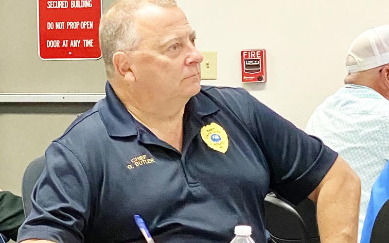 Lake City Police Department Chief Gerald Butler listens to reports from agencies during Tuesday morning’s briefing at the Emergency Operations Center. Butler said his department would be increasing the number of officers on the streets to protect businesses and evacuees parked randomly around the city waiting out Hurricane Milton. (TODD WILSON/Lake City Reporter)