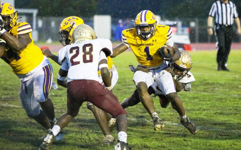 Columbia receiver Zamarion Jones tries to escape a tackle from St. Augustine defensive back Braylon James (3) on Sept. 25. (BRENT KUYKENDALL/Lake City Reporter)