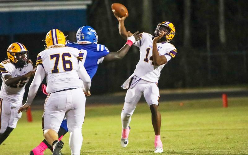 Columbia quarterback Xavier Collins throws a pass under pressure against Clay on Friday night. Collins finished with four touchdown passes. (BRENT KUYKENDALL/Lake City Reporter)