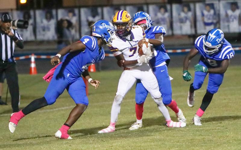 Columbia receiver Kyren Caldwell catches a touchdown pass while surrounded by Clay defenders during his team’s 49-13 win Friday. (BRENT KUYKENDALL/Lake City Reporter)