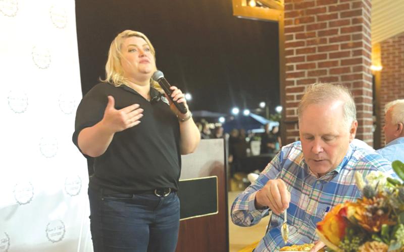 U.S. Rep. Kat Cammack (R-Gainesville) speaks during Thursday’s Farm To Table fundraiser as Ag Commissioner Wilton Simpson dines on chicken pot pie. (COURTESY)