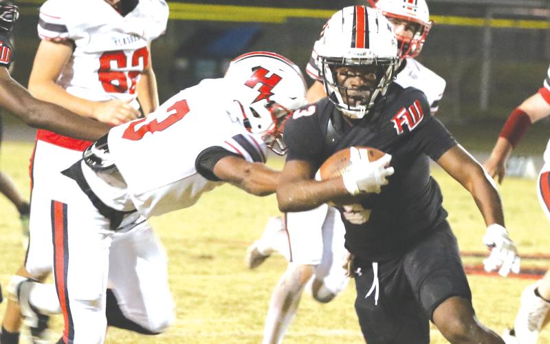 Fort White running back Elijah Gardner runs through the Hilliard defense last Friday. (MORGAN MCMULLEN/Lake City Reporter)