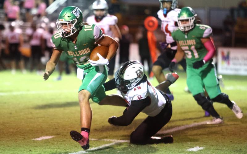 Baker County linebacker Seth Chestnut dives to try and tackle Suwannee receiver Koy Frier on Friday. (PAUL BUCHANAN/Lake City Reporter)