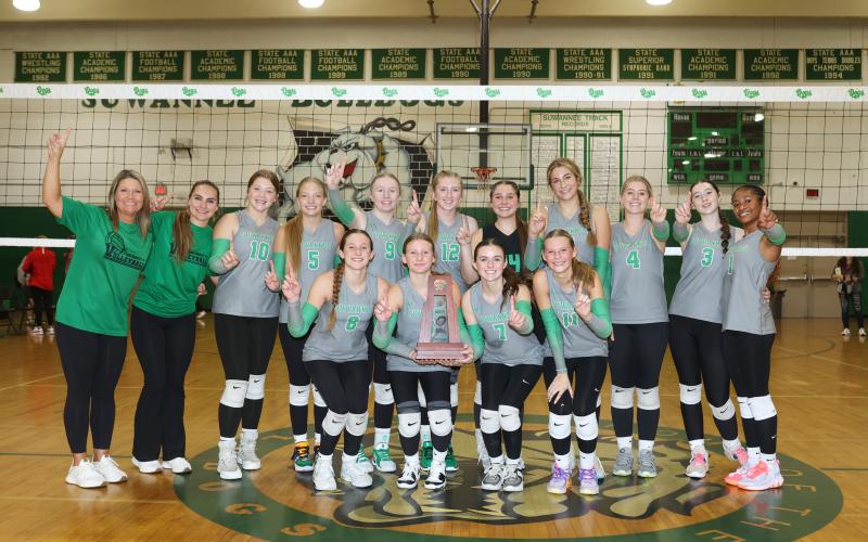Suwannee's volleyball team poses with the District 2-4A championship trophy after rallying to beat Wakulla on Thursday night. (PAUL BUCHANAN/Lake City Reporter)