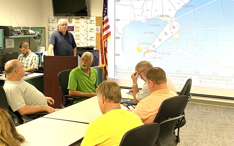 Shayne Morgan describes Hurricane Milton, which now is a Category 5. Seated clockwise from left are Rocky Ford, Ron Williams, Kevin Kirby and Robby Hollingsworth.  (TODD WILSON/Lake City Reporter)