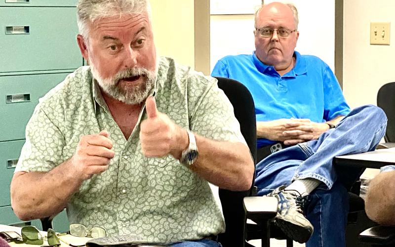 Columbia County Assistant County Manager Kevin Kirby (left) explains the need for an amended contract with storm cleanup contractors during an emergency county commission meeting Thursday morning. Commissioners unanimously approved the measure. Emergency Management Director Shayne Morgan is in the background. (TODD WILSON/Lake City Reporter)