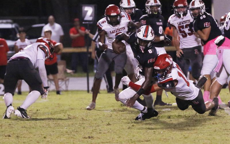 Fort White quarterback Jayden Jackson is tackled by Lafayette’s Joseph Smith on Oct. 4. (JAMIE WACHTER/Lake City Reporter)